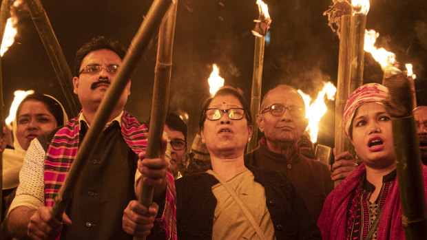 Indians participate in a torch light procession to protest against the Citizenship Amendment Bill (CAB) in Gauhati, India.