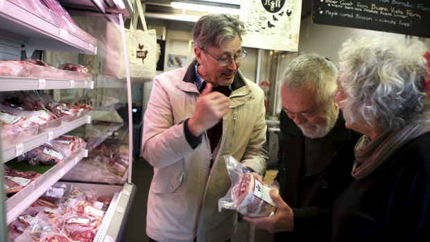 Butcher and Providore Grant Hilliard selling a lamb cut to his regular customers Cherry and Peter Best in his Marrickville retail store 'Feather and Bone'.