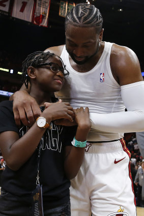 Dwyane Wade hugs Zion Wade after his final NBA game earlier this year.