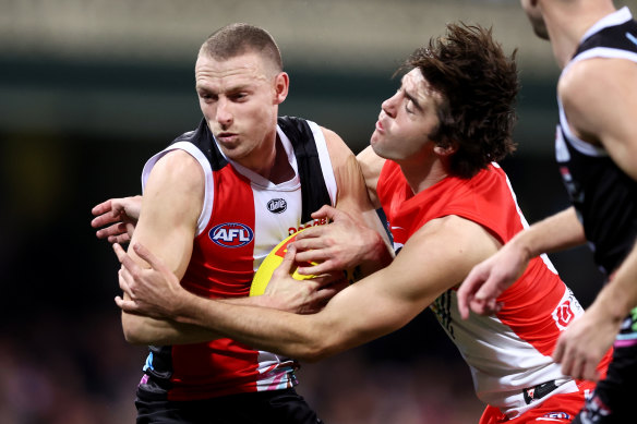 Callum Wilkie is tackled by Logan McDonald.