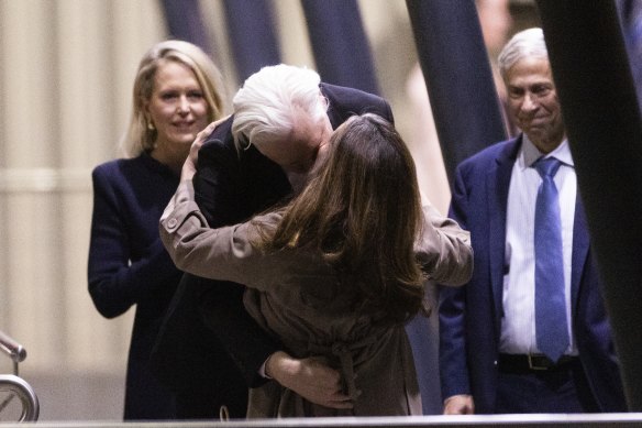 Julian Assange kisses his wife Stella Assange as lawyers Jennifer Robinson and Barry Pollack look on.