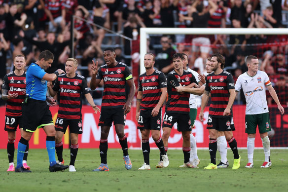 Wanderers players complain to the referee during Sunday’s match against Newcastle.