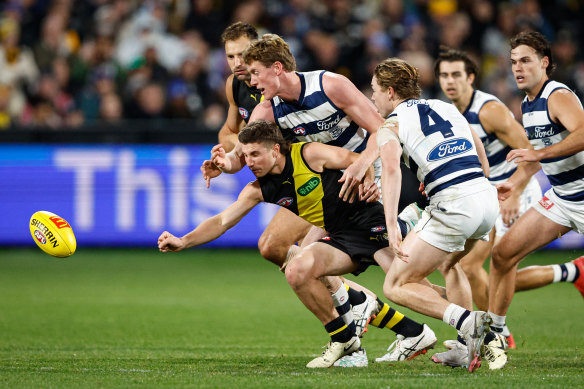 Liam Baker heads to the ball with three Cats chasing.