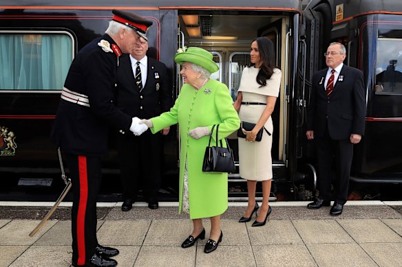 Queen Elizabeth II and Meghan, Duchess of Sussex, arrive by the royal train at Runcorn Station, in north-west England in 2018.