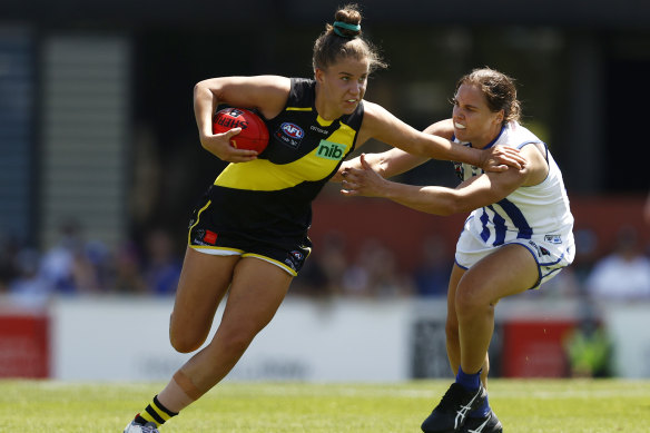 North Melbourne’s Jasmine Garner   tackles Ellie McKenzie of Richmond.
