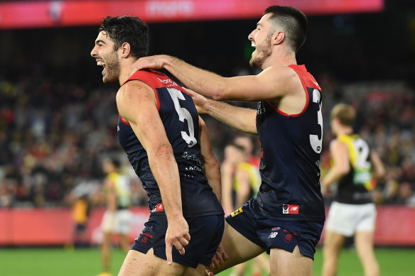 Christian Petracca is congratulated by Alex Neal-Bullen after kicking a goal for the Demons in their win over the Tigers.