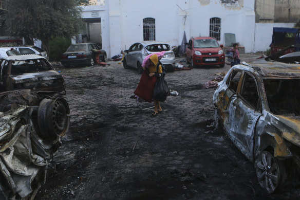 Palestinians carry belongings leaving the Al Ahli hospital. 