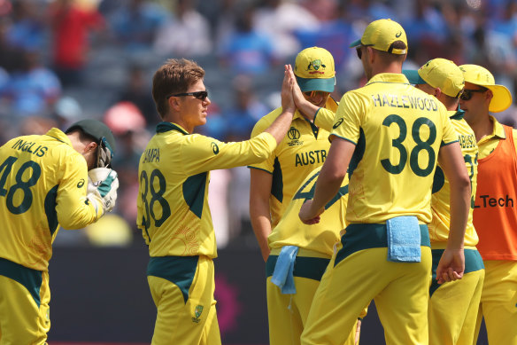 Adam Zampa strikes and his teammates celebrate.