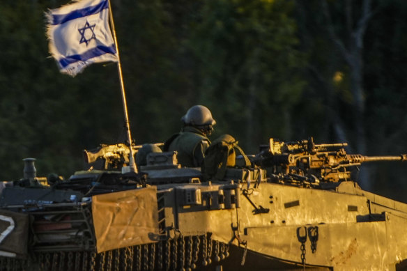 An Israeli tank moves along the Israel Gaza border on Thursday.