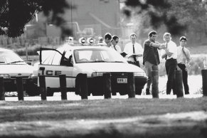Accused killer Wayne Walton, in handcuffs, re-enacts, for police, events leading up to the Wettenhall triple murder in March 1992. Pictured at the Barwon River. 
