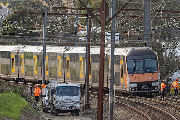 Crews work to remove debris on a Transport NSW train between Penrith and St Mary’s today.