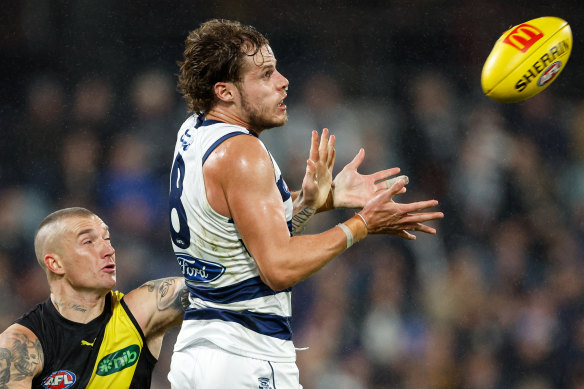 Jake Kolodjashnij of the Cats marks the ball ahead of Dustin Martin.