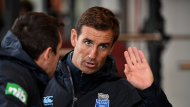 Helping hand: Andrew Johns talks tactics with Mitchell Pearce at Blues training.