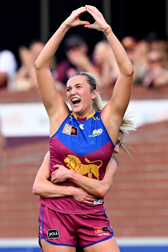 Taylor Smith of the Lions celebrates kicking a goal.