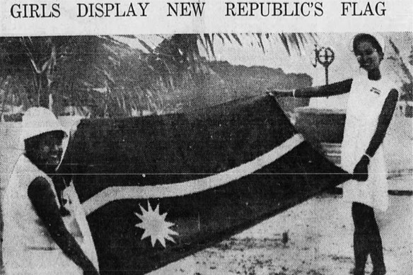 Nauruan's Rosavine Jose, 16, and Margaret Jose, 21, displays the flag of the new independent Republic of Nauru during independence ceremonies 31st January 1968.