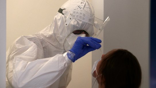 A woman gets tested for COVID-19 in Prague, Czech Republic on Saturday.