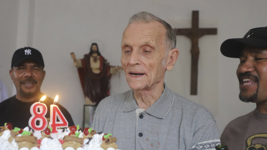 Now-defrocked Catholic priest Richard Daschbach, centre, is presented a cake during his 84th birthday in Dili. Former East Timor president Xanana Gusmao was photographed feeding Daschbach cake that day..