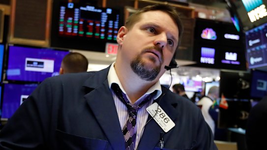 Trader Michael Milano works on the floor of the New York Stock Exchange, where stocks opened sharply lower on Thursday.