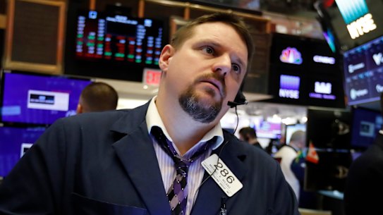 Trader Michael Milano works on the floor of the New York Stock Exchange, where stocks opened sharply lower on Thursday.
