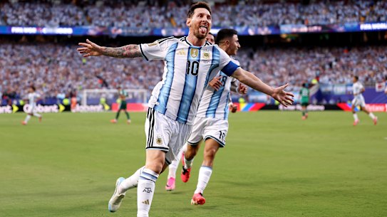 Lionel Messi celebrates after scoring the first of his three goals against Algeria.