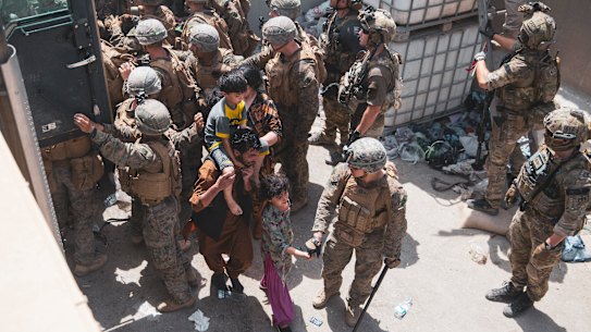 US Marines and Norweigian coalition forces assist with security at a checkpoint at the Kabul airport.