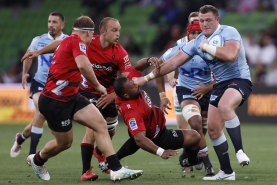 MELBOURNE, AUSTRALIA - MARCH 02: Angus Bell of the Waratahs breaks a tackle  during the round two Super Rugby Pacific match between Crusaders and NSW Waratahs at AAMI Park, on March 02, 2024, in Melbourne, Australia. (Photo by Darrian Traynor/Getty Images)