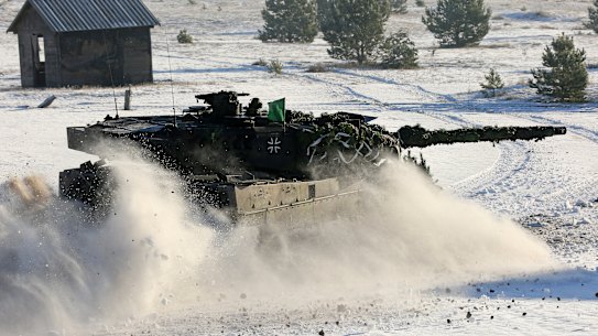 A German Bundeswehr Leopard tank drives through the snow in preparation for a Dutch-German military exercise.