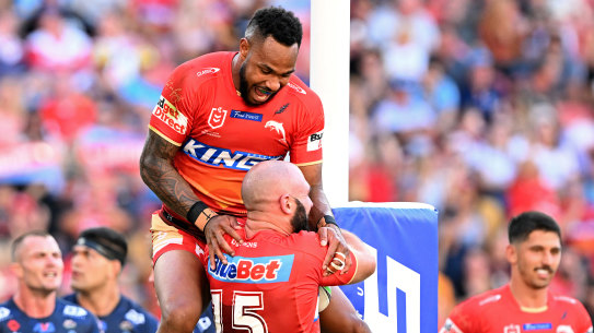 The Dolphins celebrate a Mark Nicholls try against the Titans.