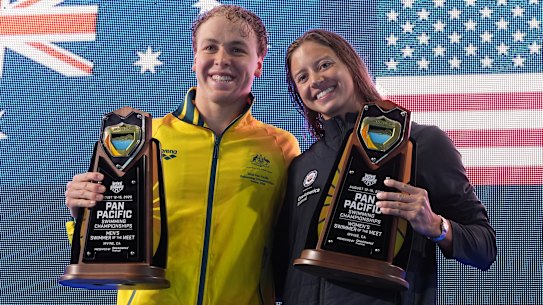 Swimmers of the meet winners Samuel Short, of Australia, left, and Kate Douglass, of the United States, hold their trophies at the Pan Pacific Championships in Irvine. 