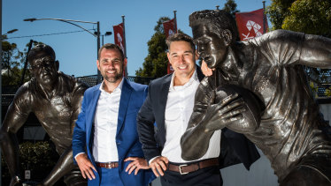 Storm legends Cameron Smith (left) and Billy Slater with their statues at AAMI Park.