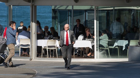 On the move: Barry Russell leaves the meeting.