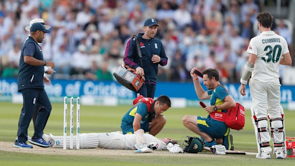 Steve Smith receiving treatment as he lies on the ground after being hit on the head by a ball bowled by England's Jofra Archer.