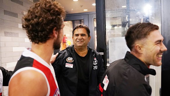 Saints be praised: Former St Kilda player Nicky Winmar celebrates the win with Luke Dunstan and Jade Gresham.
