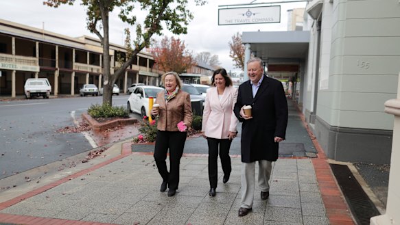 Kristy McBain and Anthony Albanese walk a cold, empty street in Yass with Yass Valley mayor Rowena Abbey (left).