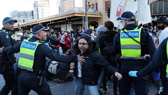 Police attempt to arrest a protester during strike action by the National Union of Students and Students for Palestine in Melbourne.