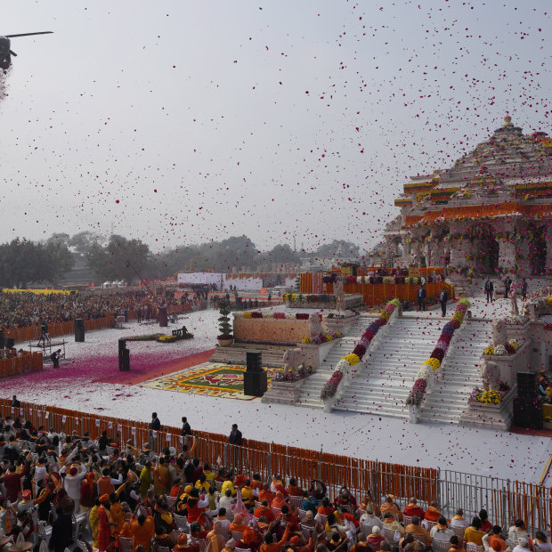 An Indian Air Force helicopter showers flower petals during the opening of a temple dedicated to Hinduism’s Lord Ram in Ayodhya, India, on Monday.