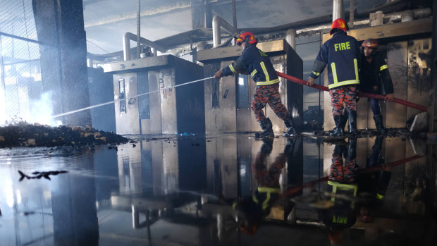 Firefighters work to douse a fire at a food and beverage factory in Rupganj, outside Dhaka, Bangladesh.