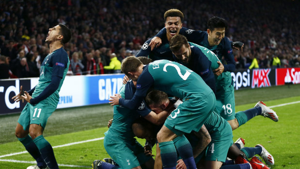 Triumphant: Tottenham players following Moura's third and decisive strike.