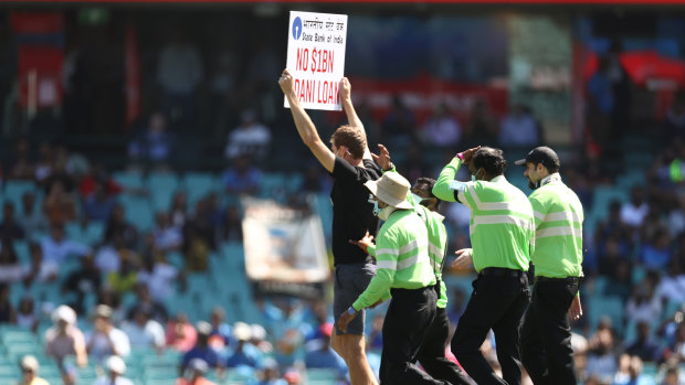 A protester walks onto the pitch during play during game one of the One Day International series between Australia and India at Sydney Cricket Ground on November 27, 2020 in Sydney.