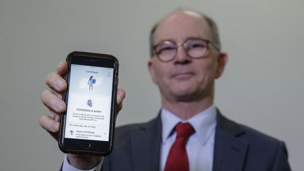 Deputy Chief Medical Officer Professor Paul Kelly with the COVIDSafe app on his phone.