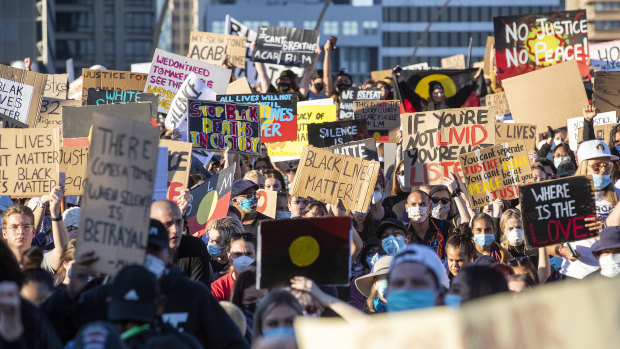 People march across the Victoria Bridge.