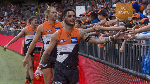 Zac Williams greets GWS Giants fans after a win at Olympic Park.