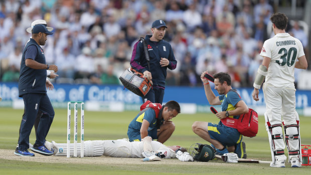 Steve Smith receiving treatment as he lies on the ground after being hit on the head by a ball bowled by England's Jofra Archer.