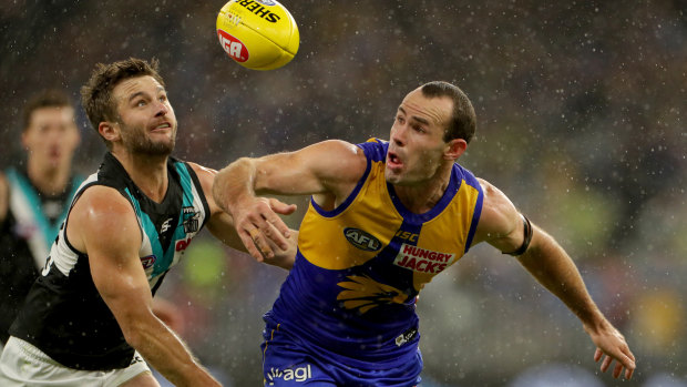 West Coast's Shannon Hurn battles Sam Gray in the wet.