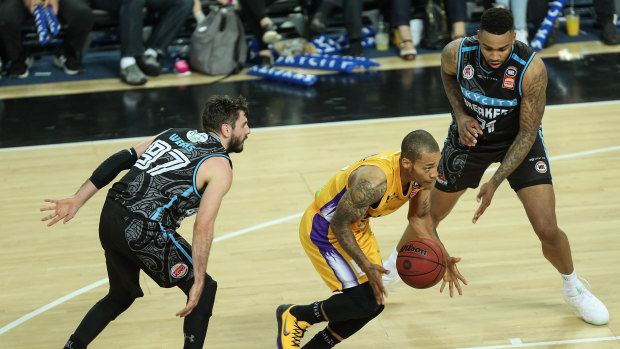 Livewire: Jerome Randle swoops on the ball between Jarrad Weeks, left, and Shawn Long of the Breakers.