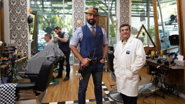 Professor Prashant Sonar (right) with Benjamin Mir, who runs the Ben Scissorhands barber shop in Kelvin Grove.