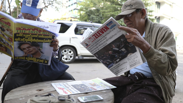 Yangon locals read newspapers headlined with Aung Sun Suu Kyi's appearance at The Hague.