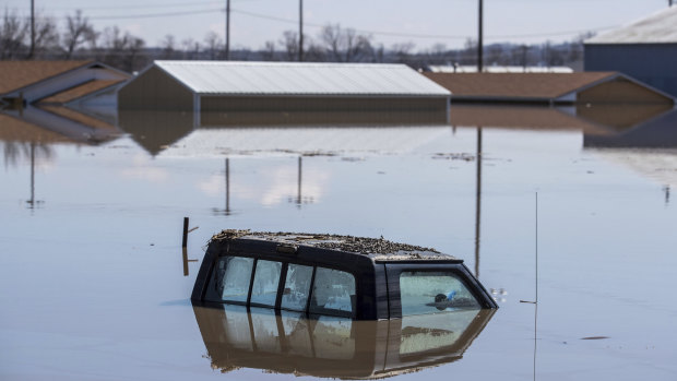 A ute is swamped by floodwaters in Hamburg, Iowa, on Wednesday.