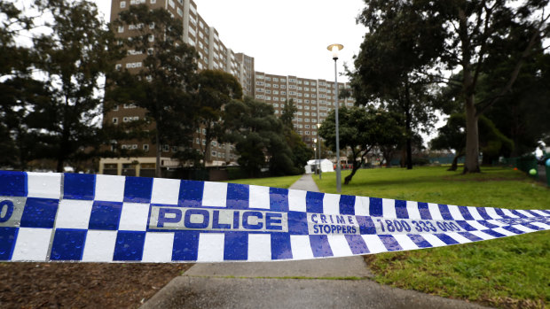 Police tape outside the public housing tower on Alfred Street.