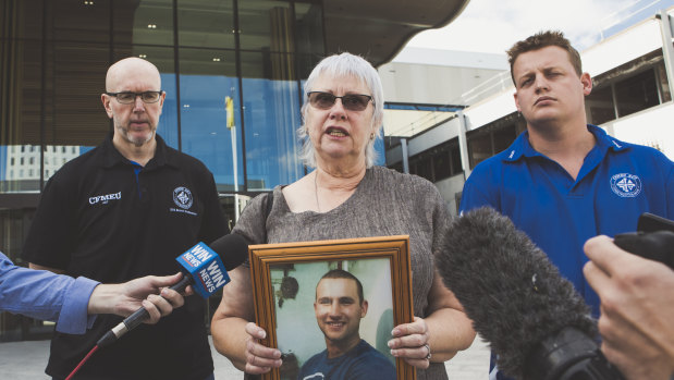 Kay Catanzariti holding a photo of her son Ben outside ACT Magistrates Court
